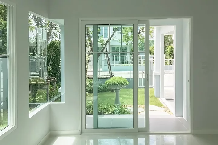 Interior atmosphere minimal style design of empty room show white wall with sliding door and glass windows looking through the outdoor garden.