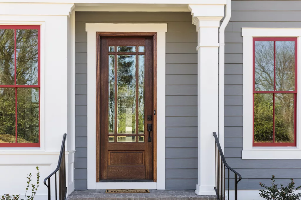 Elegant front door with iron railing and fiberglass.