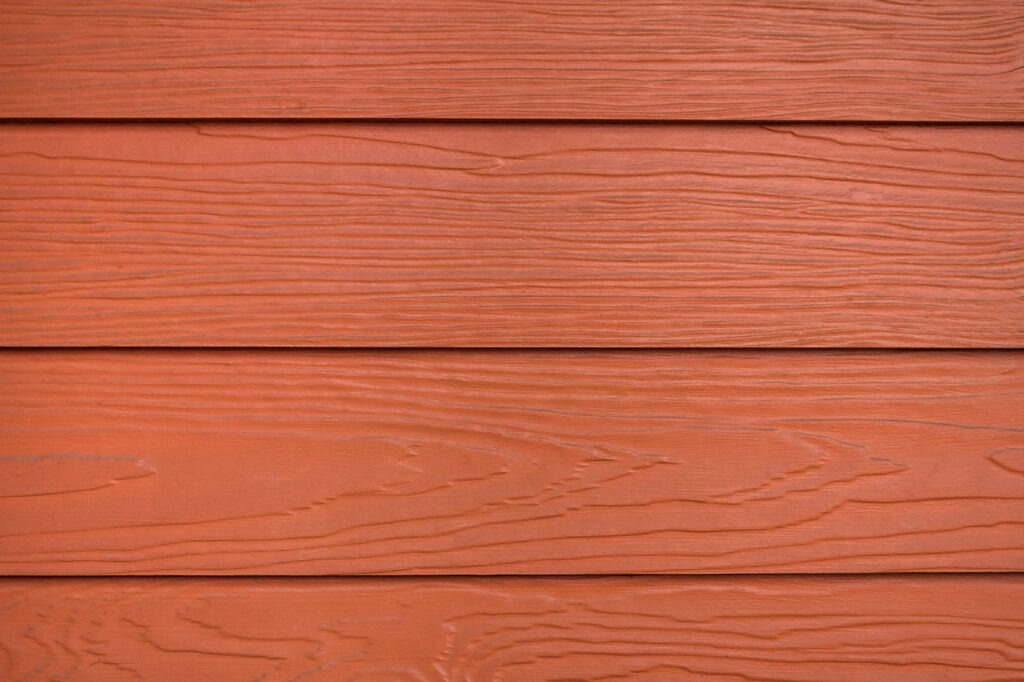 Close up red or brown wood substitute board and high quality of fiber board texture and background for design and architect ,Beautiful wooden plank patterns from cement striped wood wall