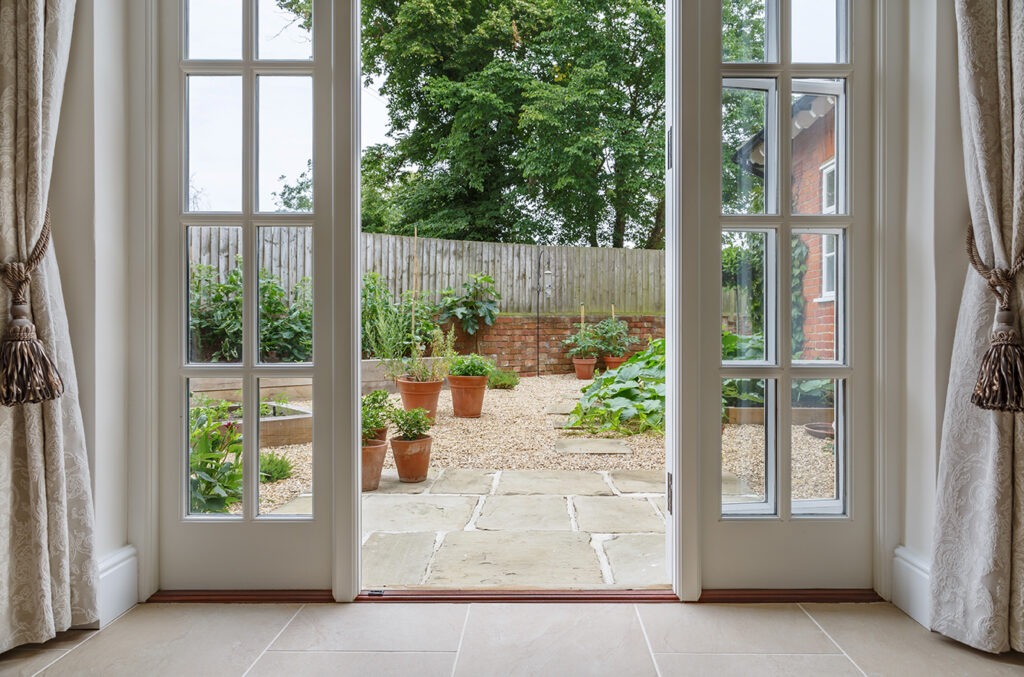 inside house with french doors leading to a courtyard kitchen garden