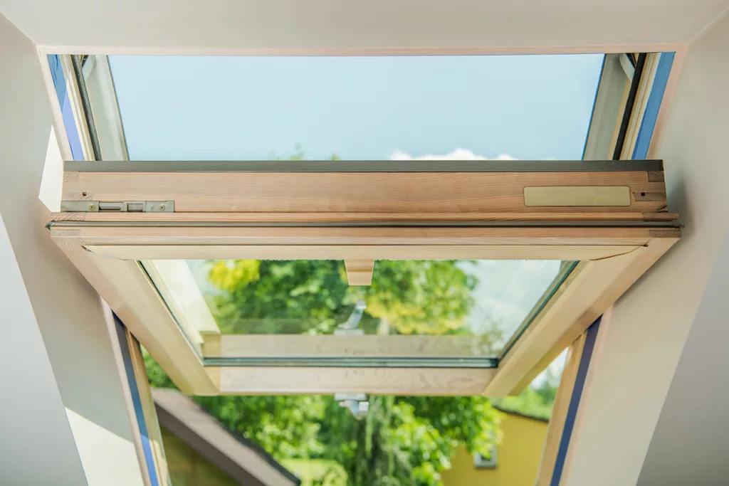 Closeup of an Open Wooden Roof Window. Brand New Installation at Residential Building.
