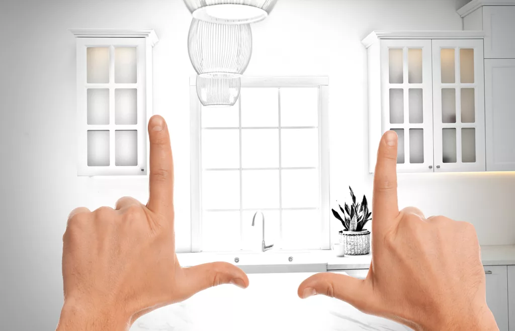 Woman showing frame gesture and making kitchen real out of drawing