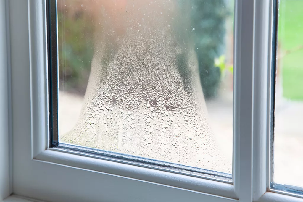 Close up of blown double glazed unit. Failed window glazing with condensation inside, UK